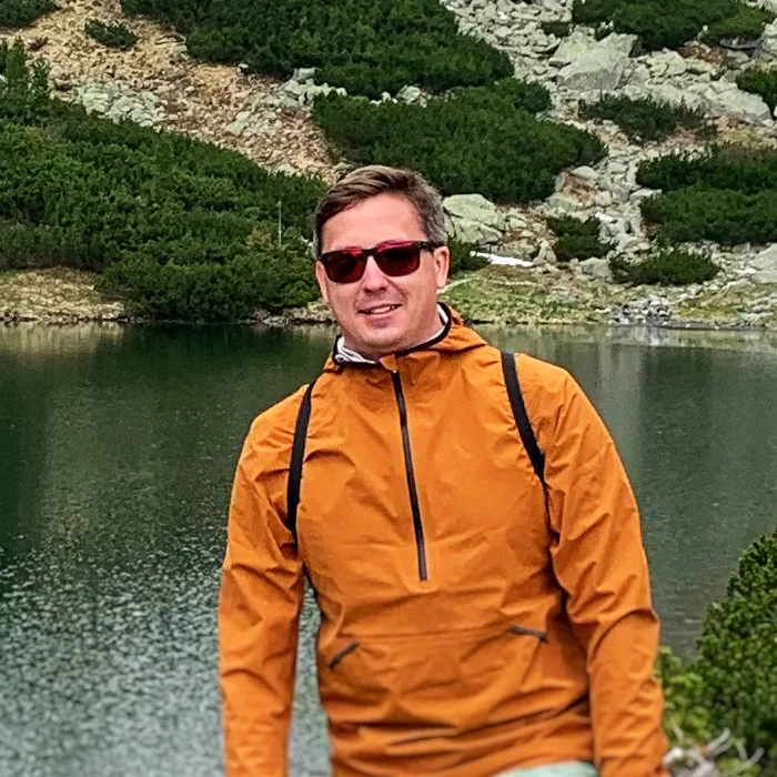 Portrait of Lukas Sabaliauskas outdoors by a mountain lake